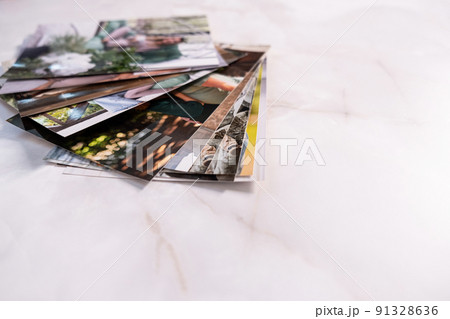 woman sitting at desk and looking at printed photos, remember nostalgia for a day of rest. photography cards, background. Mock up woman sitting at desk and looking at printed photos, remember nostalgia for a day of rest. photography cards, background. Mock up 91328636