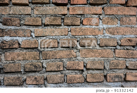 An old brick wall textured and pattern for background usage as a backdrop design. 91332142