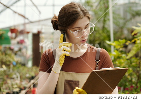 Florist taking an order by phone 91332723
