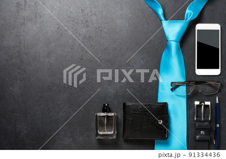Men's accessories on a black concrete background. The concept of a successful modern man. Copy space Men's accessories on a black concrete background. The concept of a successful modern man. Copy space 91334436