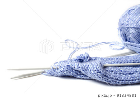 Balls of blue yarn and knitting needles. White background. Copy space. The concept of women 's needlework 91334881