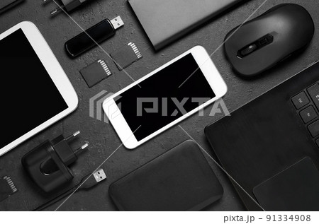 Electronic gadgets on a black concrete background. Concept of accessories for successful business. Flat lay. 91334908