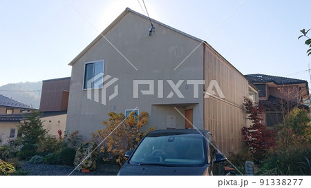 青空に映える切妻屋根のグレー色のオシャレで素敵でスタイリッシュでモダンな憧れのカッコイイ2階建て住宅 91338277