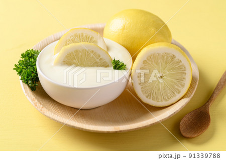 Lemon yogurt in bowl on yellow, Healthy eating and beauty skincare 91339788