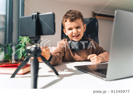 Boy is studying online at laptop Boy is studying online at laptop 91340977