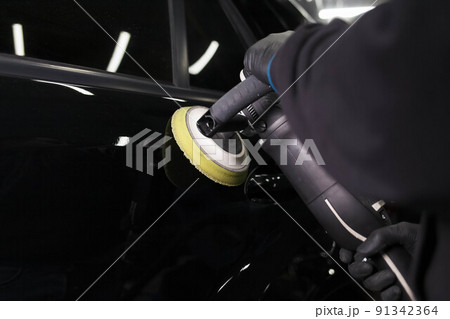 Car body polishing process at the detailing workshop. 91342364
