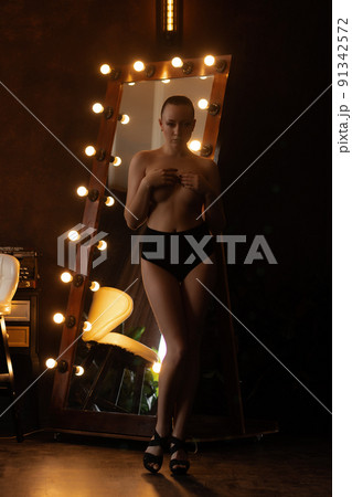 Alluring woman covering breast in studio Alluring woman covering breast in studio 91342572