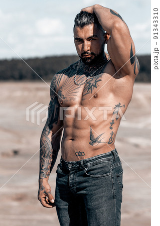 Sexy portrait of muscular handsome topless male model at the beach Sexy portrait of muscular handsome topless male model at the beach 91343310