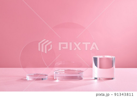 Glass Geometric podium for product display. Monochrome platform with ribbed acrylic sheets and crystal triangle on pink background. Stylish background for presentation. Minimal style 91343811