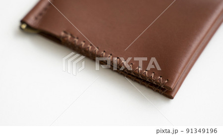Empty classics brown leather handmade money clip wallet on white background. Leather accessories. 91349196