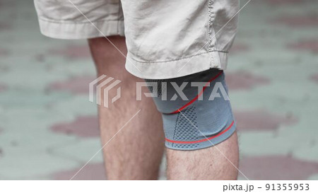 Knee pad on a man's leg. knee bandage. Fixing Orthosis. Knee pad on a man's leg. knee bandage. Fixing Orthosis. 91355953