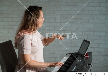 Female singing teacher at online lesson on digital tablet Female singing teacher at online lesson on digital tablet 91358874