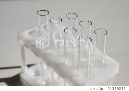 Empty test tubes in a rack on a white background. Empty test tubes in a rack on a white background. 91359255