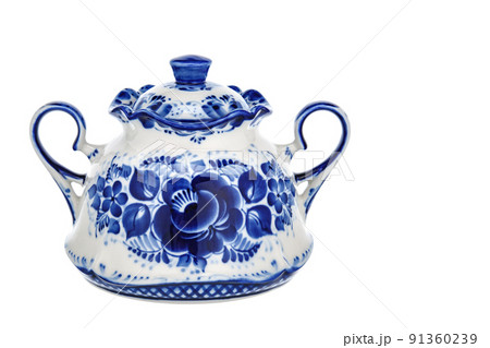 Tableware Empty Sugar Bowl Casket Figurine Sculpture Porcelain Ceramic Isolated on white background. Cobalt Blue color is traditional folk floral painting. Decor for interior of premises. Tableware Empty Sugar Bowl Casket Figurine Sculpture Porcelain Ceramic Isolated on white background. Cobalt Blue color is traditional folk floral painting. Decor for interior of premises. 91360239