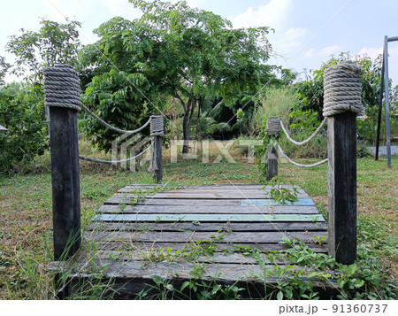 small wooden bridge in garden a beautiful green area for children to run and play. small wooden bridge in garden a beautiful green area for children to run and play. 91360737