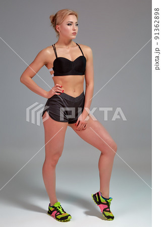 Fitness woman in black tank top and shorts, studio shot. 91362898