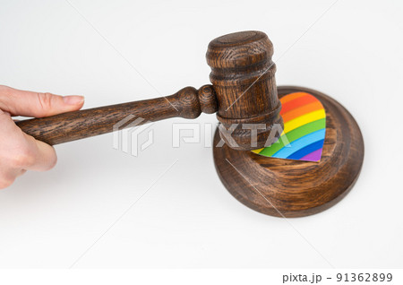 The judge hits a heart with a rainbow flag with a gavel. 91362899