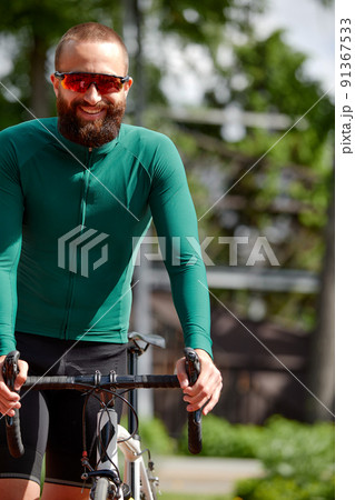 Man on bicycle rides through summer park on sunny day. Man on bicycle rides through summer park on sunny day. 91367533