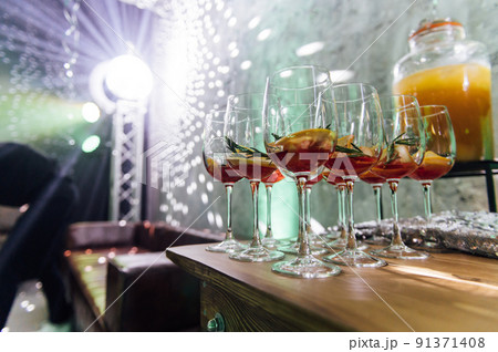 Glasses with different cocktails. Long and short cocktails at a party with disco lighting Glasses with different cocktails. Long and short cocktails at a party with disco lighting 91371408