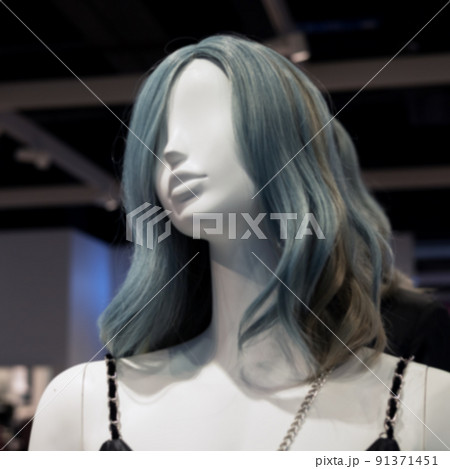 Female white mannequin with grey-blue hair. Fashion clothing store. Defocused photo Female white mannequin with grey-blue hair. Fashion clothing store. Defocused photo 91371451