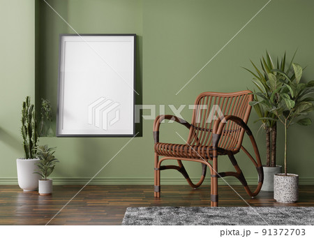 Empty vertical picture frame on green wall in modern room. Mock up interior in scandinavian, boho style. Free, copy space for your picture. Rattan armchair, plants. 3D rendering. Empty vertical picture frame on green wall in modern room. Mock up interior in scandinavian, boho style. Free, copy space for your picture. Rattan armchair, plants. 3D rendering. 91372703