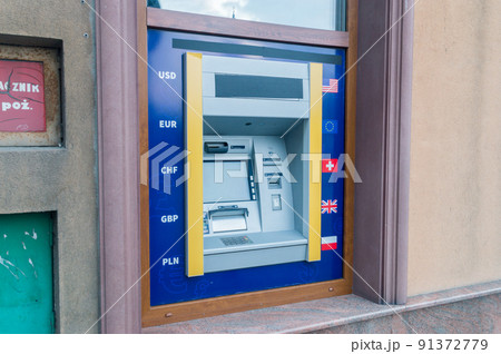 ATM machine on wall. Automated teller machine on the wall with currency codes USD, EUR, CHF, GBP and PLN. 91372779