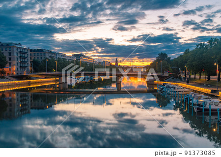 Sunrise view on Aura (Aurajoki) river with bridge and Turku Cathedral in the background in Turku, Finland. Sunrise view on Aura (Aurajoki) river with bridge and Turku Cathedral in the background in Turku, Finland. 91373085