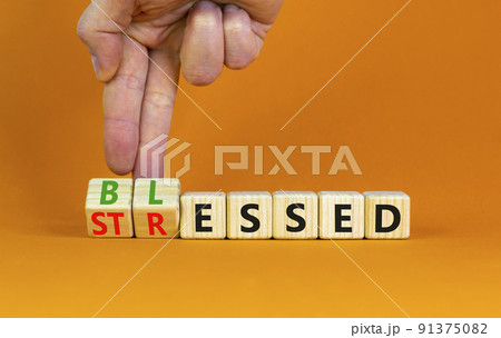 Blessed or stressed symbol. Businessman turns wooden cubes and changes the concept word Stressed to Blessed. Beautiful orange table orange background. Business blessed or stressed concept. Copy space. Blessed or stressed symbol. Businessman turns wooden cubes and changes the concept word Stressed to Blessed. Beautiful orange table orange background. Business blessed or stressed concept. Copy space. 91375082