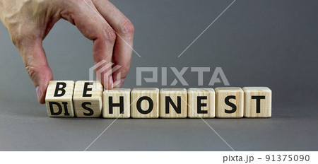 Be honest or dishonest symbol. Businessman turns cubes and changes concept words Dishonest to Be honest. Beautiful grey table grey background. Business be honest or dishonest concept. Copy space. 91375090
