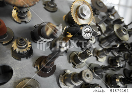 Background image of various cutting blades for processing metal on silver surface Background image of various cutting blades for processing metal on silver surface 91376162