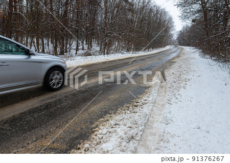 driving in winter after a snowfall, ice on the road, temperatures below zero driving in winter after a snowfall, ice on the road, temperatures below zero 91376267