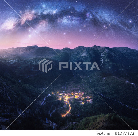 Milky Way arch and village on the mountain at night in summer Milky Way arch and village on the mountain at night in summer 91377372