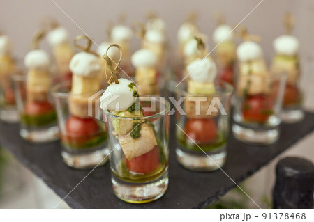 a lot of cold snacks on buffet table, catering. 91378468