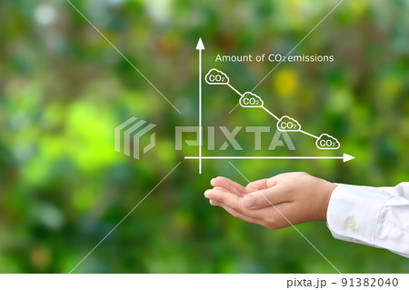 二酸化炭素削減のグラフを掲げる子供の手 91382040