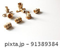 Plumbing faucet and brass fittings on the white background repairing or replacing different equipment 91389384