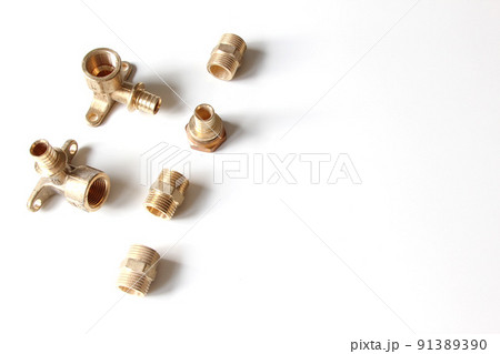 Plumbing faucet and brass fittings on the white background repairing or replacing different equipment Plumbing faucet and brass fittings on the white background repairing or replacing different equipment 91389390