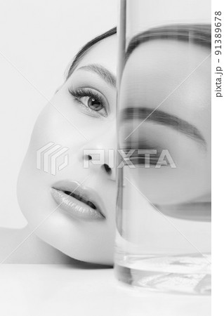 beautiful girl in bottle with water. Black and white Portrait 91389678