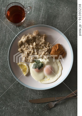 Healthy breakfast oatmeal and fried eggs 91393238