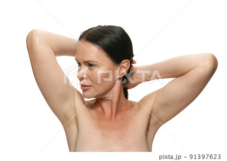 Close-up portrait of middle age, 44 years old beautiful woman with long black hair on white background. Beauty, spa, age-related changes, face lifting and skin care concept 91397623