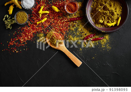 Exotically Spice Mix - spice, herbs, powder top view over dark background. Cooking and spicy food concept. Copy space Exotically Spice Mix - spice, herbs, powder top view over dark background. Cooking and spicy food concept. Copy space 91398093