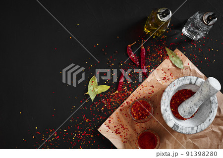 Dried and crushed red chili pepper in stone mortar. Copy space Dried and crushed red chili pepper in stone mortar. Copy space 91398280