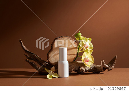 Front view of cosmetic jar decorated with branch tree and flower in brown background Front view of cosmetic jar decorated with branch tree and flower in brown background 91399867