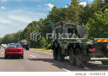 German armoured semi-trailer cargo truck carrier drives military convoy highway road. NATO troops moving reloceation rapid reaction force reinforcement eastern Europe . Sweden Finland fortification 91400128