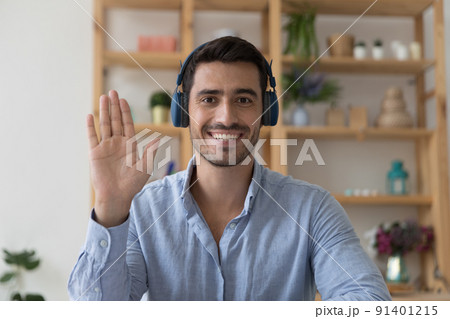 Hispanic man in headphones greet friend start video call Hispanic man in headphones greet friend start video call 91401215