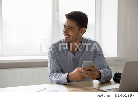 Businessman distracted from work on laptop use modern smartphone 91401297