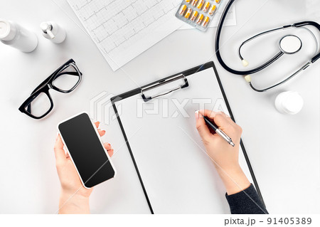 Doctor's work with stethoscope and copybook on hospital desk background. Top view 91405389