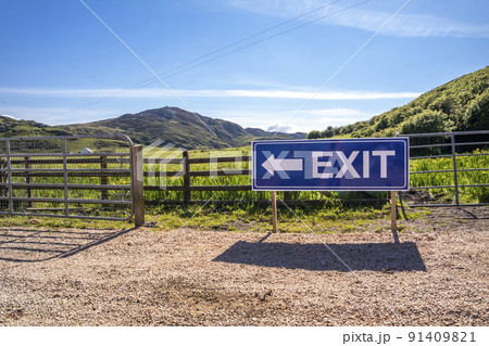 Exit sign on wooden fence of a farm and camping site 91409821