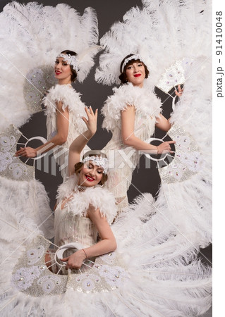 Attractive women in white art deco costumes 91410048