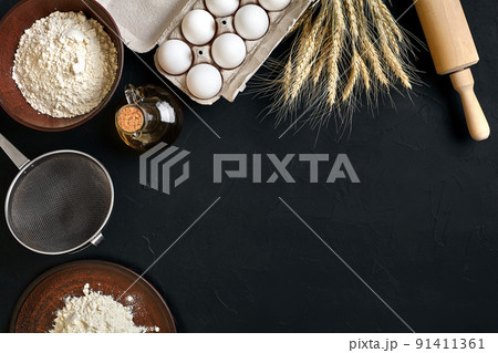 Pasta cooking ingredients on black kitchen table. Top view with space for your text Pasta cooking ingredients on black kitchen table. Top view with space for your text 91411361