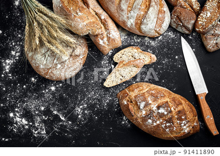 Mixed breads on black table. Top view with copy space. Mixed breads on black table. Top view with copy space. 91411890